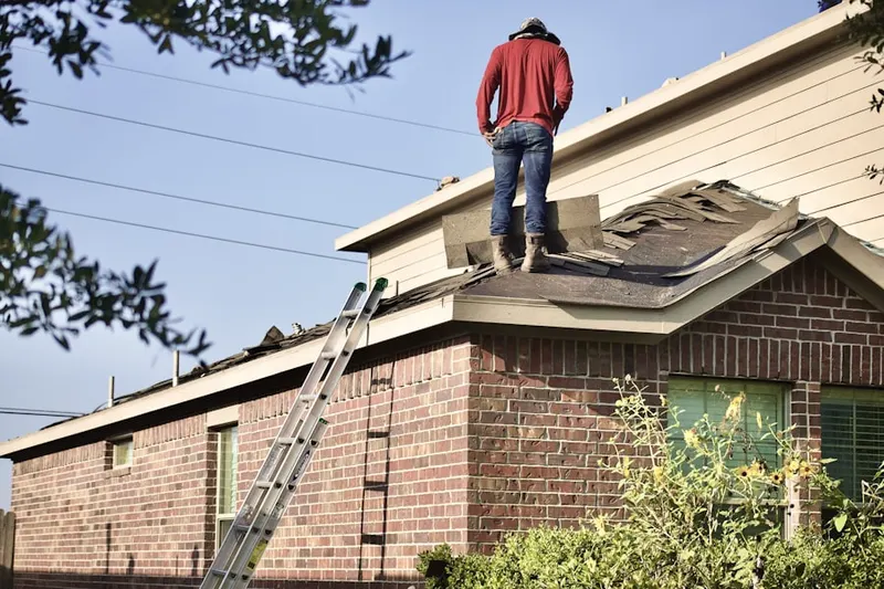 Professional roofer working on a residential roof in Boca West